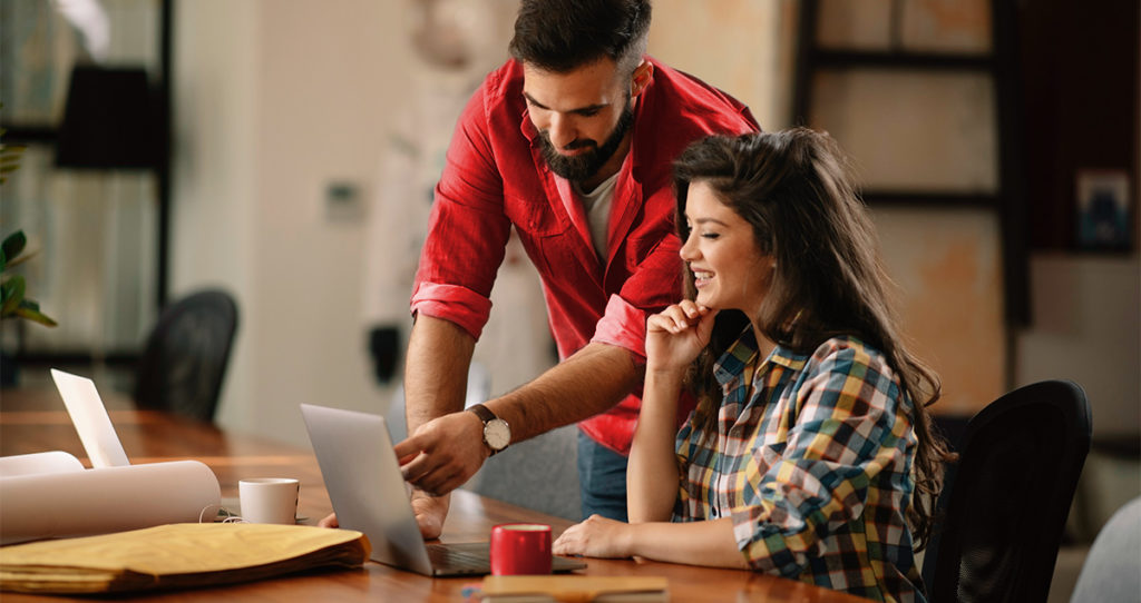 Two people looking at a computer