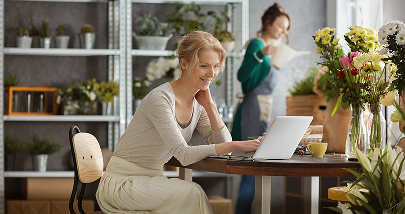 Florist sitting at a desk looking at a computer