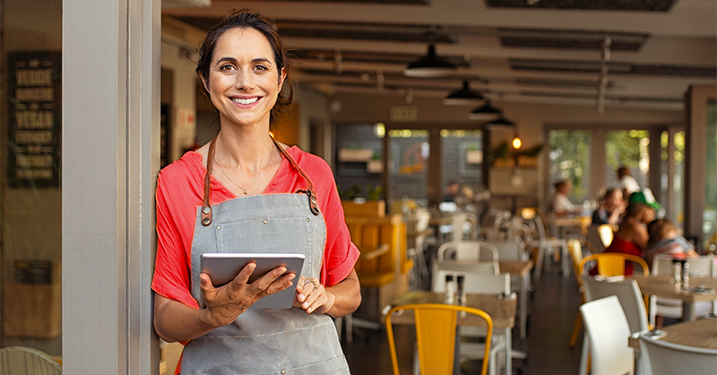 Woman in a restaurant holding a tablet
