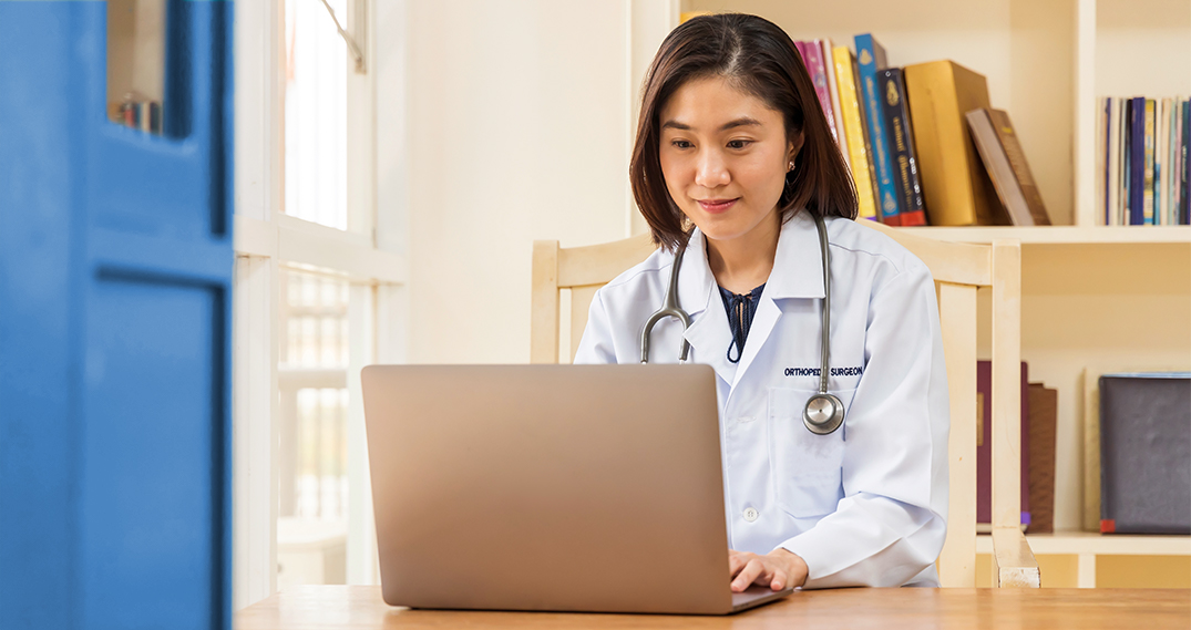 Doctor in an office working on a compter