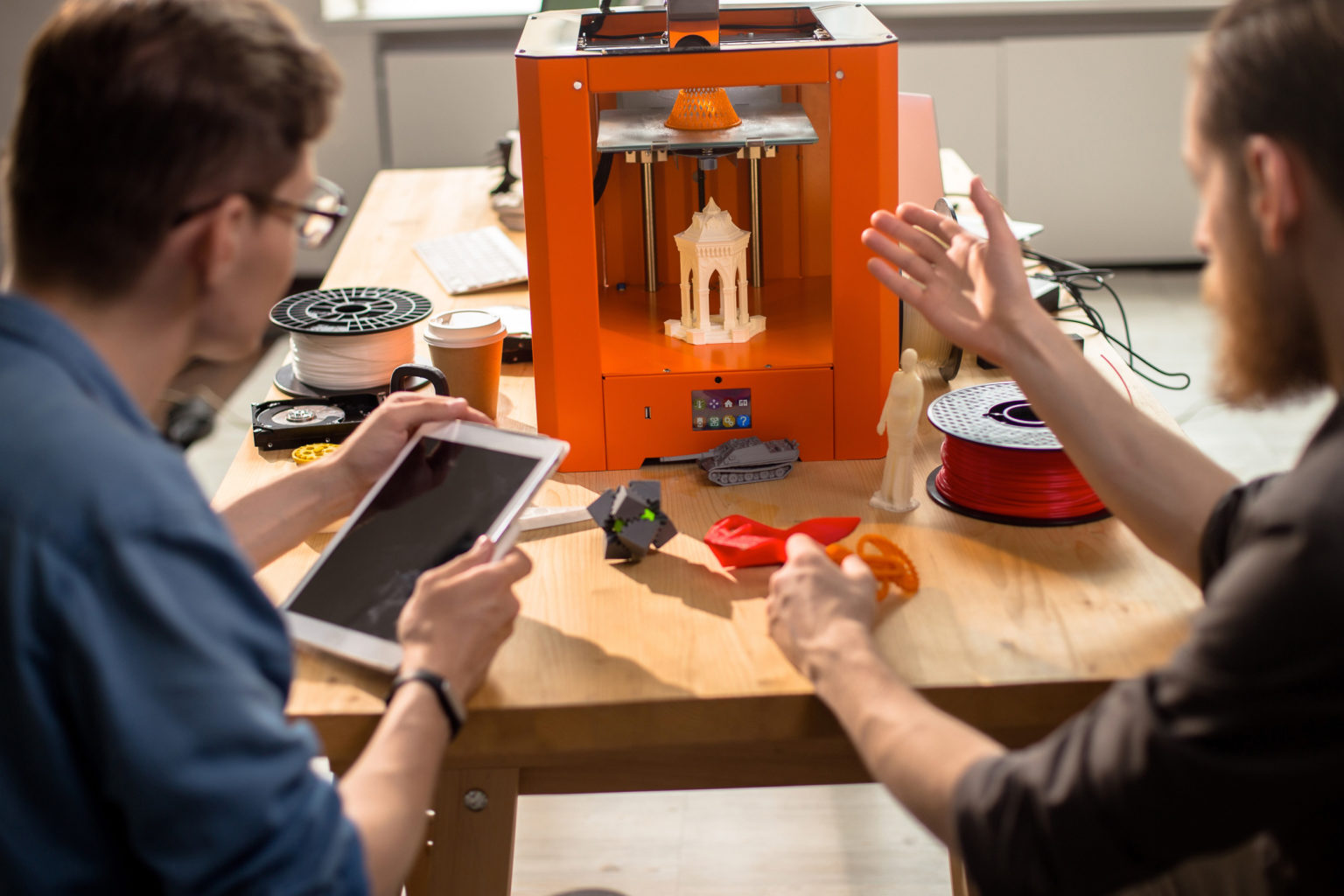 Two men working on a digital printer