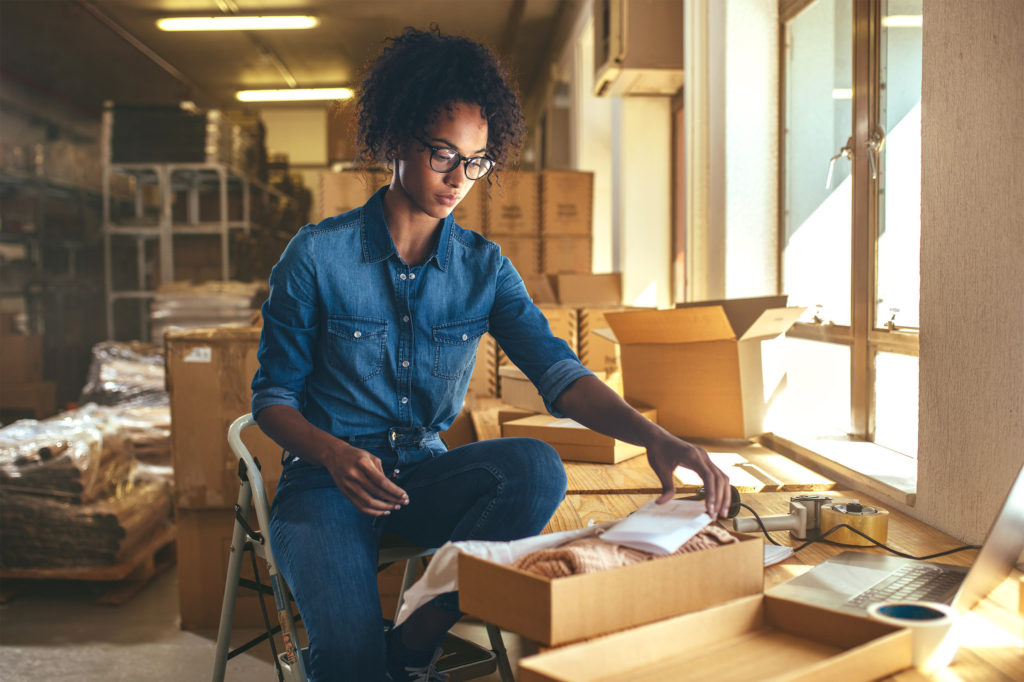 Woman packaging things in a box