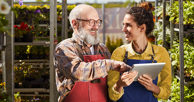 Two people conversating over a tablet