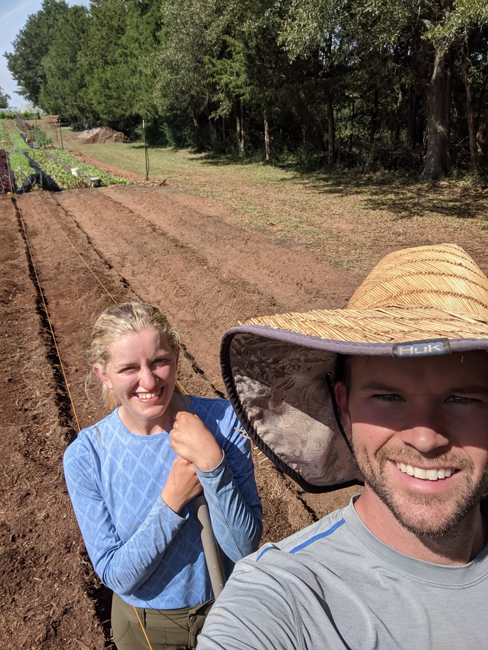 Two people standing in their garden