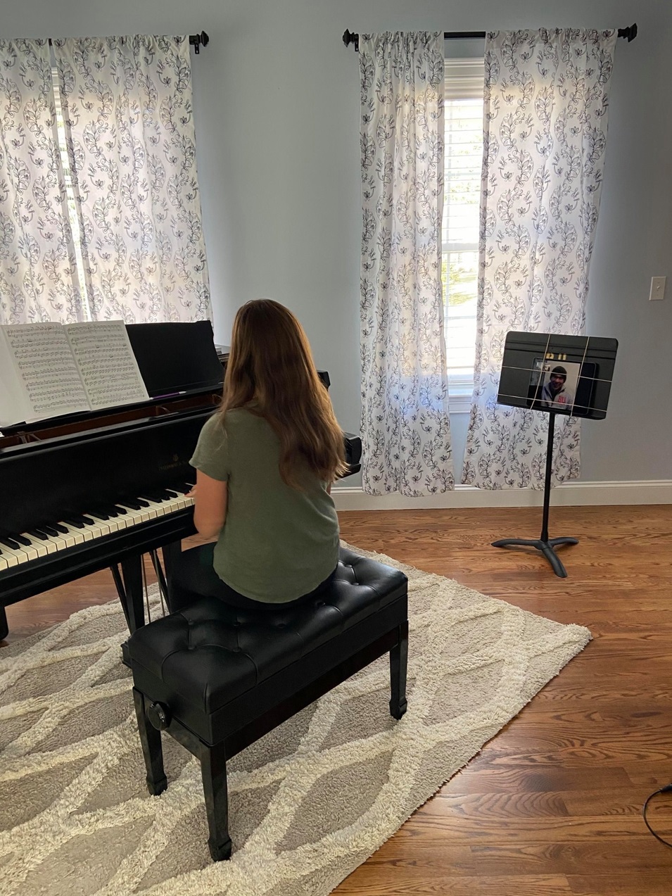 A woman sitting and playing the piano