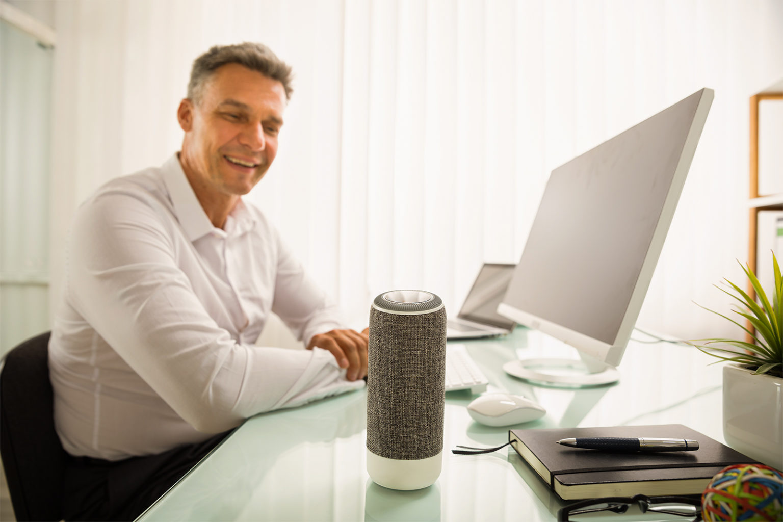 Man sitting at a desk looking at an IoT device