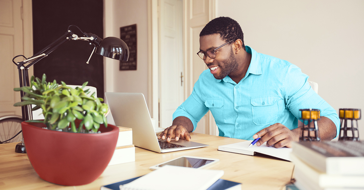 Man sitting in a home office working a computer