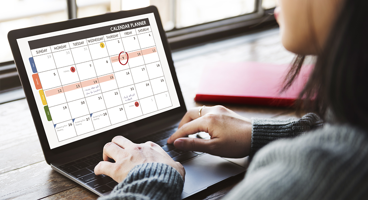 Woman on a computer working on a calendar