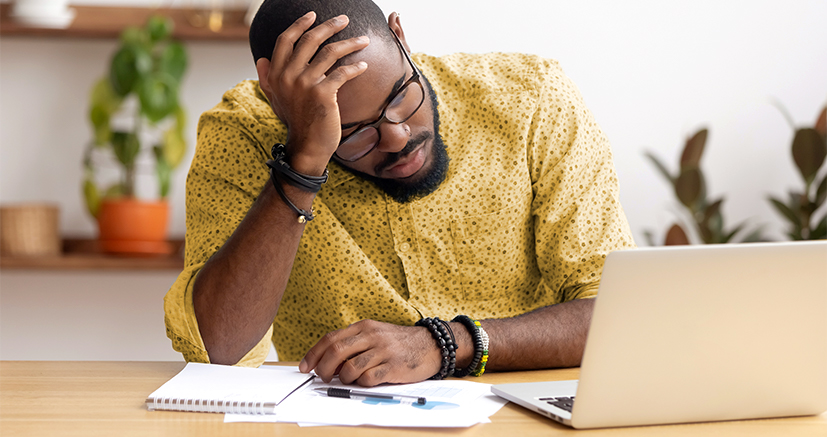 Man sitting at a compuer with a puzzled look on his face