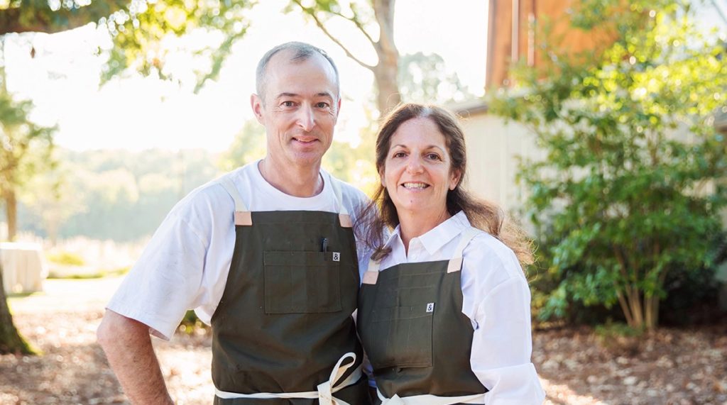 Man and a woman wearing aprons
