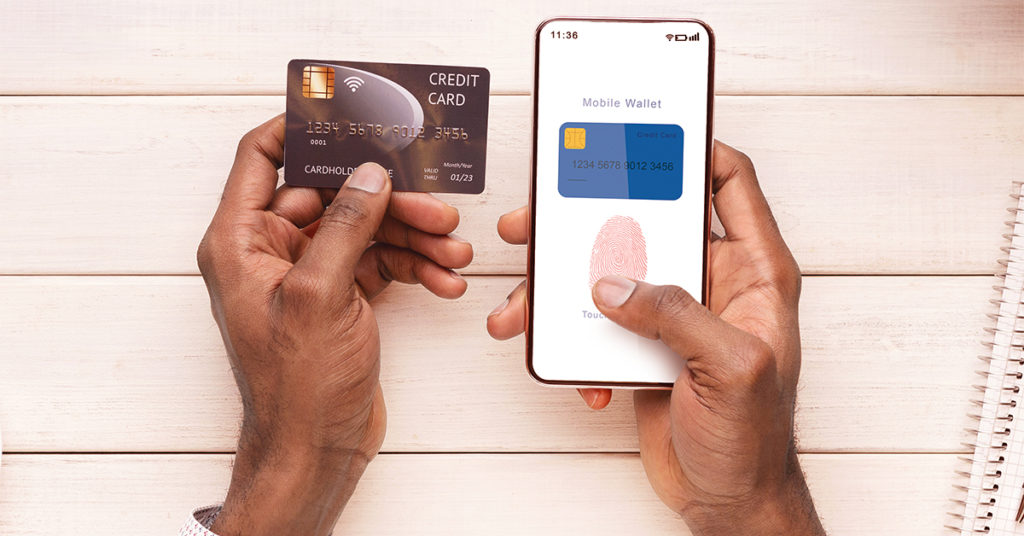 Hands holding a phone and a credit card