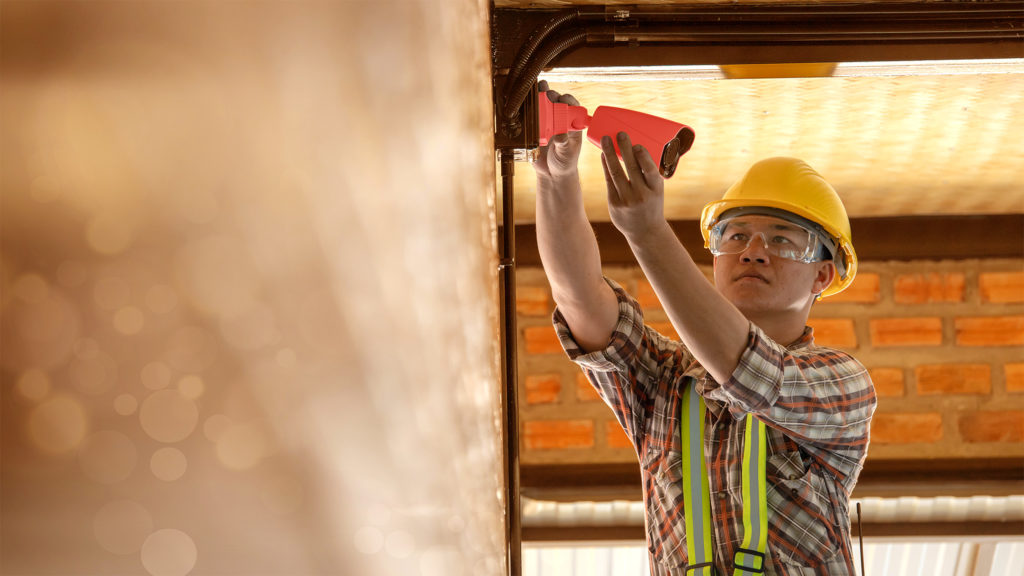 A worker installing a security camera