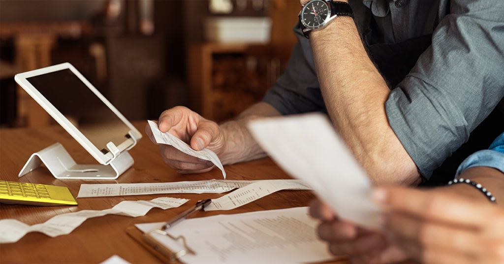 Hands holding a receipt