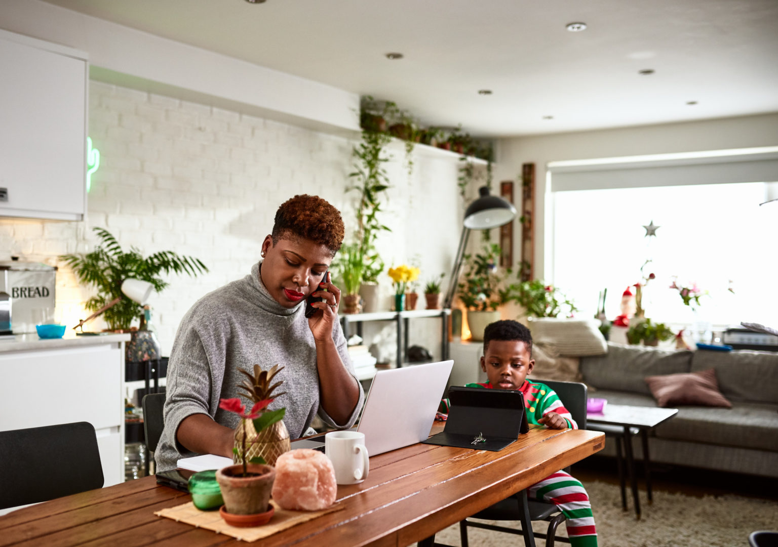 A mother and son on a computer and tablet