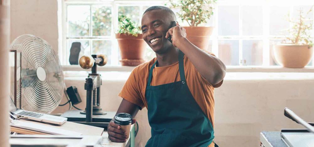 Man with coffee on phone