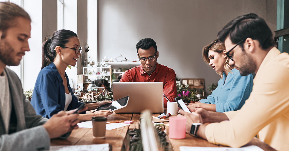 People sitting at a table working on computers