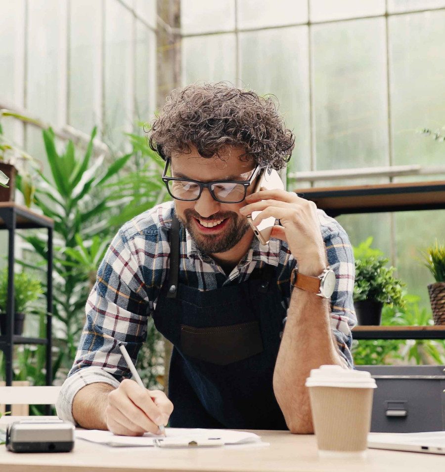 man on phone taking notes