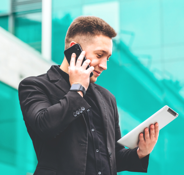 Man on cell phone and tablet