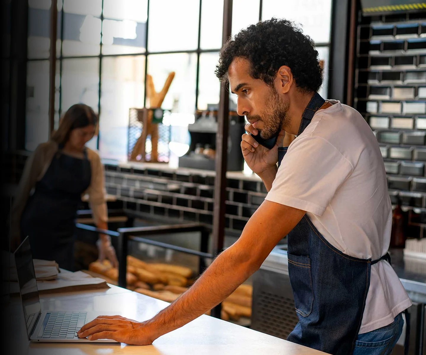 Business owner on a phone call and the computer