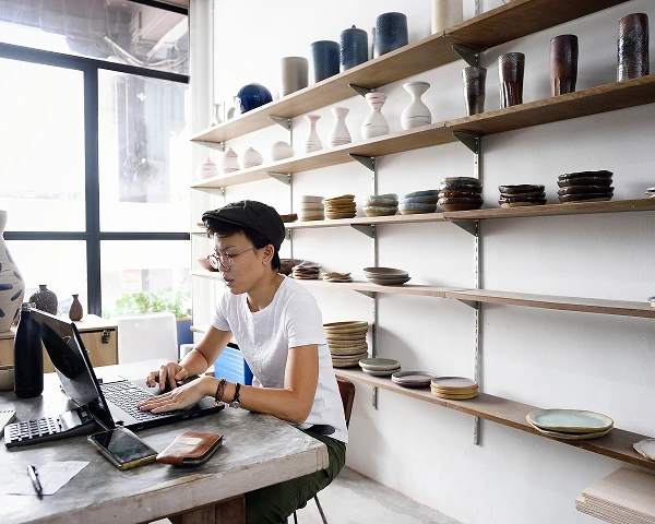 A woman sitting in a coffee shop using Wi-Fi