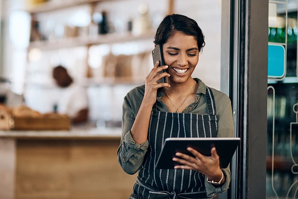 A woman using a table and smartphone with SmartVoice