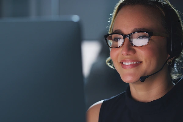 A woman in glasses looking at a laptop screen with Premium Tech Pro